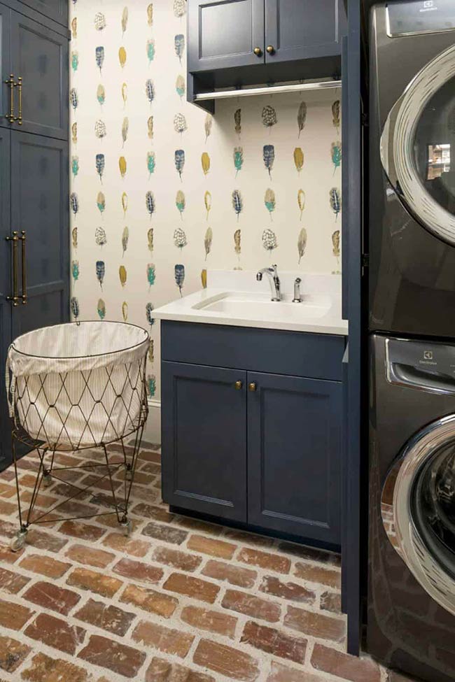 Whimsical wallpaper and Hale Navy cabinets make this laundry room feel fun and lively. Thin brick floors add texture and durability. Bright colors and clever storage options turn an ordinary laundry room into a space that’s both practical and inspiring.