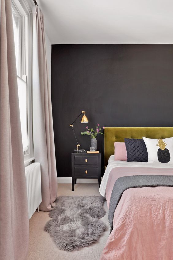 That yellow-green headboard is such a cool surprise against the matte black wall. I really like the cute pineapple pillow sitting on the pink sheets. It makes this pink and black bedroom feel fun and a little bit quirky.