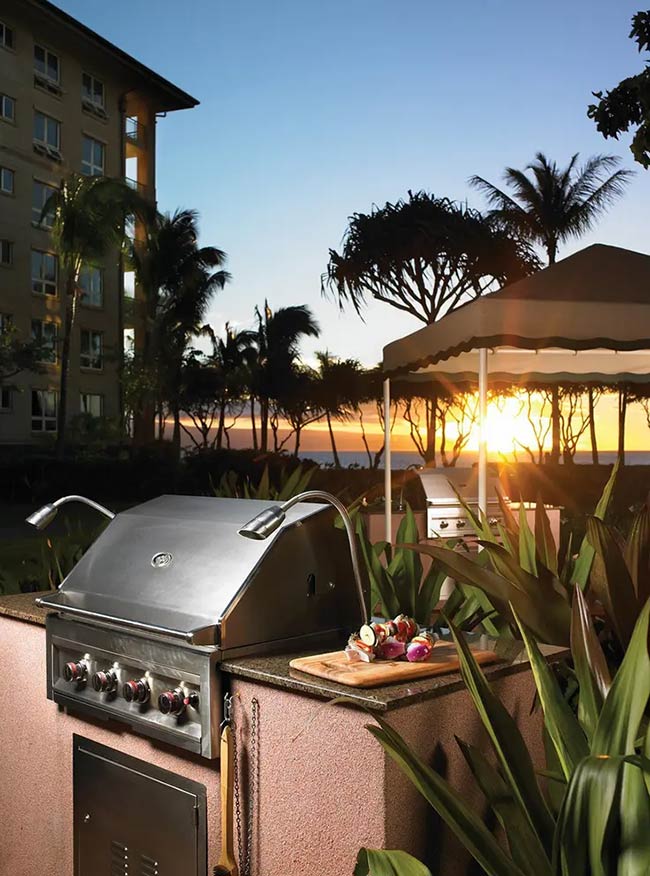 Grilling right by the beach at sunset must be amazing. The simple stucco island holds a shiny stainless steel grill and fits right into the tropical landscape. Palm trees and the ocean view make this the perfect spot for a summer party.
